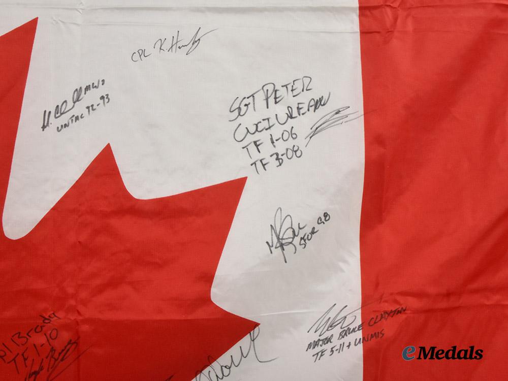 canada,_commonwealth._a_canadian_flag_signed_by_captain_wayne_johnston,_founder_of_the_wounded_warriors_fund,_along_with_the_signatures_of_other_members_of_the_canadian_forces___m_n_c3731