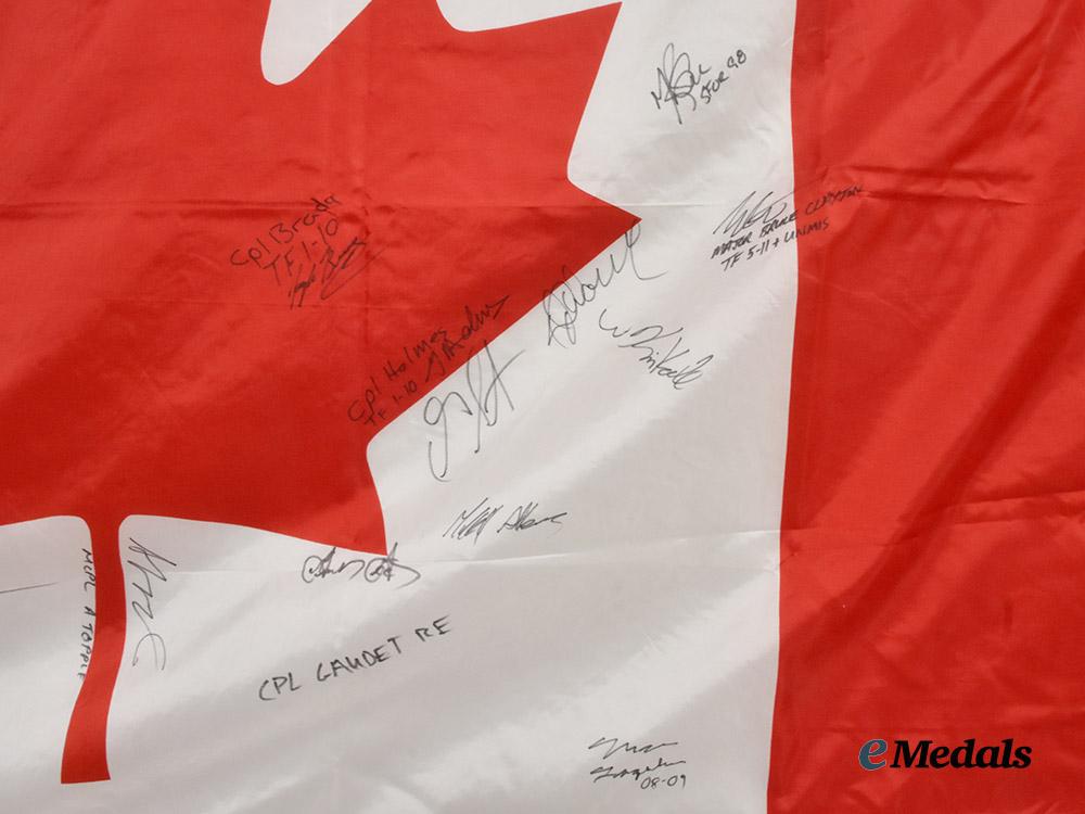 canada,_commonwealth._a_canadian_flag_signed_by_captain_wayne_johnston,_founder_of_the_wounded_warriors_fund,_along_with_the_signatures_of_other_members_of_the_canadian_forces___m_n_c3732