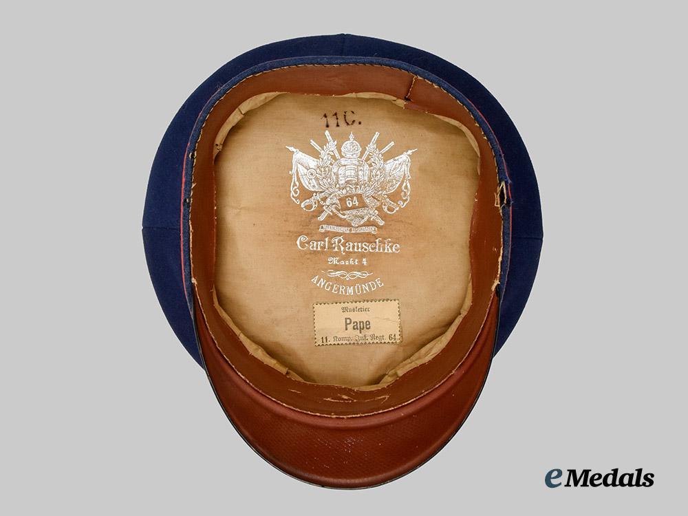 germany,_imperial._a_prussian_infantry_dark_blue_visor_cap,_named_and_unit-_attributed_example,_by_carl_rauschke___m_n_c8240