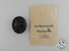 A Second War German Black Grade Wound Badge; Tombac Version In Its Packet Of Issue