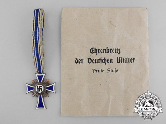 a_bronze_grade_mother’s_cross_with_original_packet_of_issue_by_wilhelm_schröder&_co._d_7839